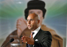 Сейф аль-Ислам Каддафи на фоне изображения отца. Фото с сайта johnbatchelorshow.com