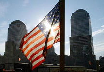 An American flag flutters over Ground Zero in New York City Tuesday Sept. 10, 2002 as the sun sets. Tommorrow marks the one year