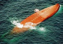A raft dropped from a French Navy plane floats next to the capsized ferry MS Joola in this photo taken Friday, Sept. 27, 2002, o