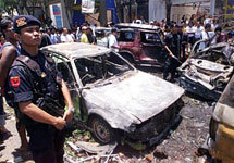 Indonesian police officers stand guard at the site of a bomb blast in Denpasar, Bali, Indonesia, in this Oct. 13, 2002 file phot