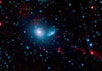 Система NGC 5291. Псевдоцветное изображение. Источники с яркой PAH-эмиссией, в том числе и приливно-отливные карликовые галактики TDGs, здесь носят красноватый оттенок. Изображение NASA/JPL-Caltech/Cornell Univ