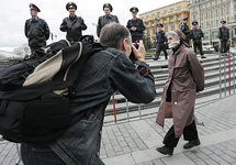 Участница флэш-моба против цензуры на фоне оцепленной милицией площади. Фото Д.Борко/Грани.Ру