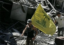 Флаг ''Хизбаллы'' на руинах в Бейруте. Фото АР