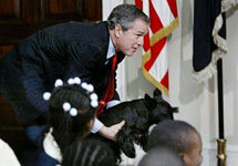 President Bush (news - web sites) grabs his dog Barney after it came into the room and frightened area children as Bush particip