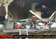 На месте теракта в Хомсе. Кадр сирийского телевидения