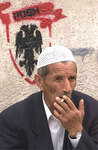 Македонский албанец. На стене - эмблема Демократической партии албанцев. Фото AP